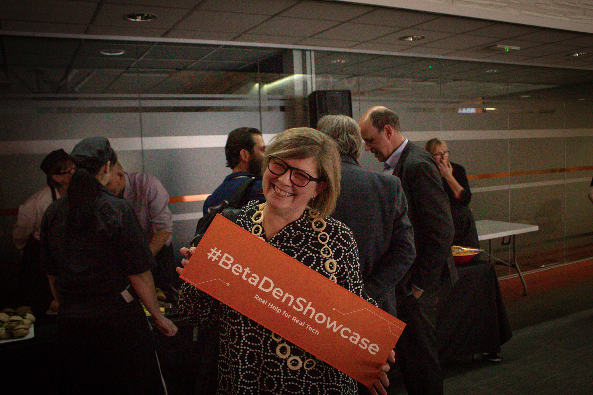 Jenny Rhode from PLINX holding up the #BetaDenShowcase sign